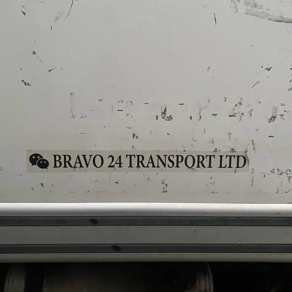 The Bravo 24 Transport Ltd. name on the side of one of the company's box trucks.
