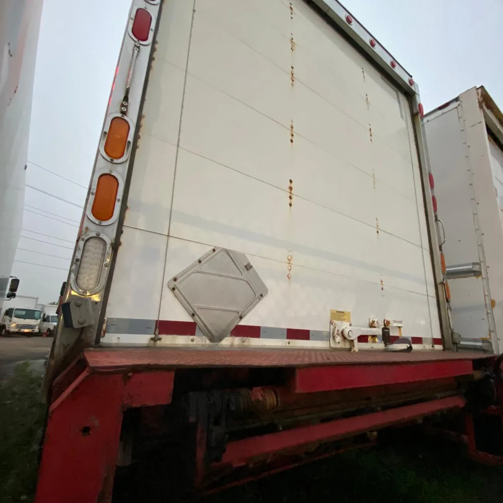 The back of a loaded Bravo 24 Transport Ltd. box truck, liftgate down, ready to roll.